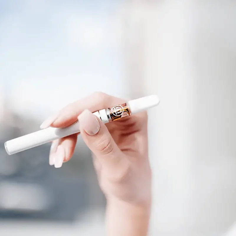 Woman holding a cannabis pen in her hand