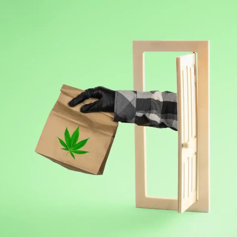 Hand handing cannabis products on the door