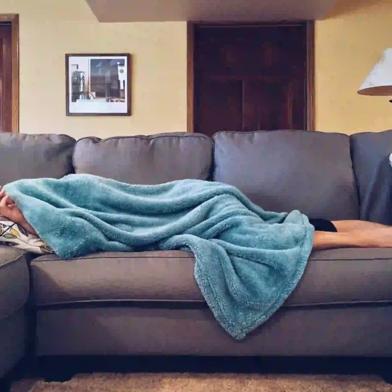 Girl Sleeping on the couch with a blanket