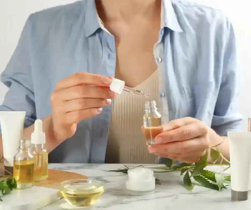 Girl pouring oil on the bottle