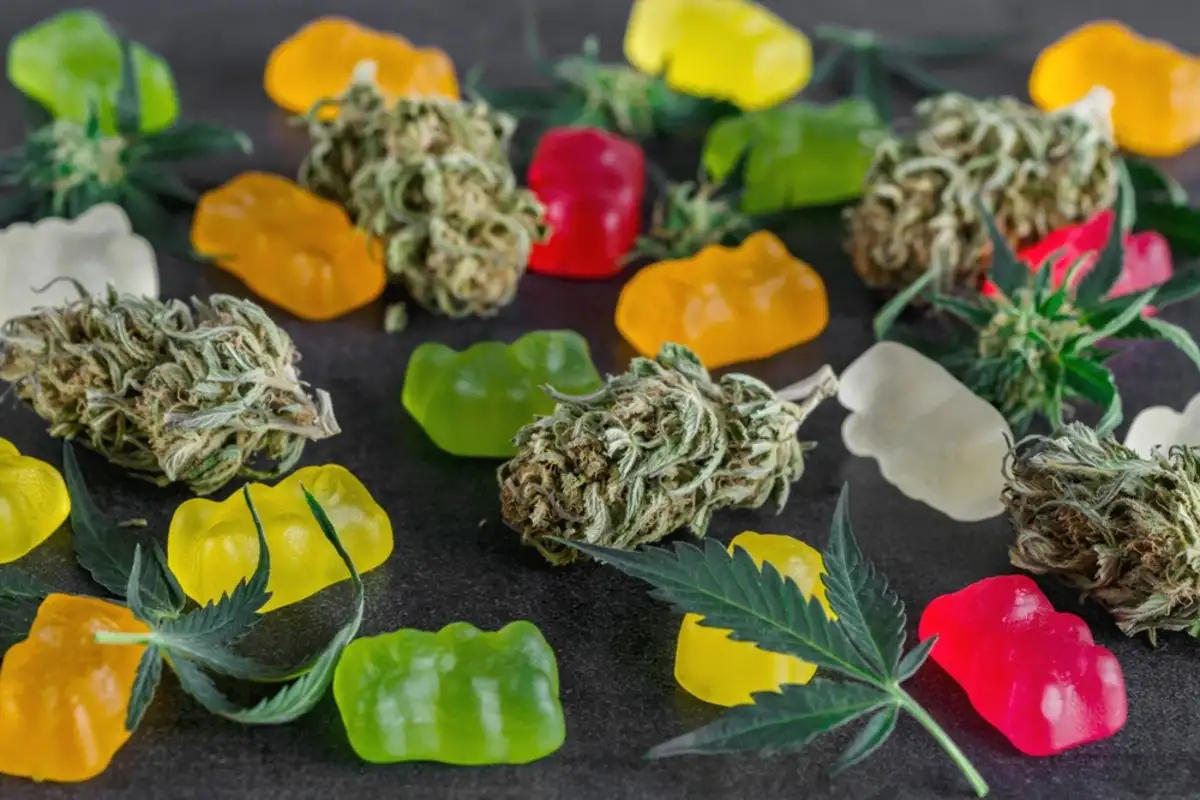 Cannabis and gummy bears sitting on top of a table