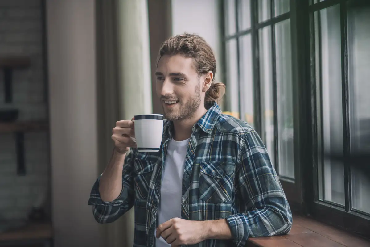 Energetic man having a cup of coffee