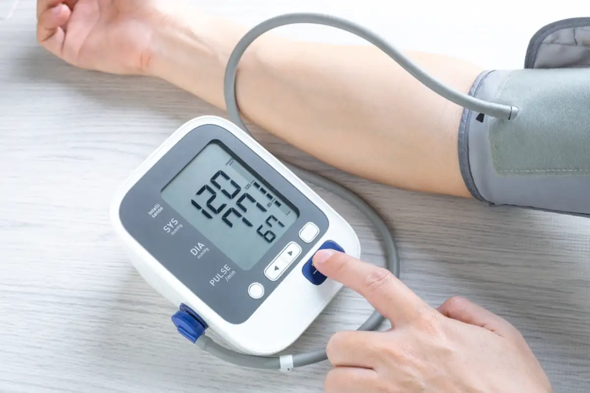 Man checks blood pressure monitor and heart rate monitor with digital pressure gauge