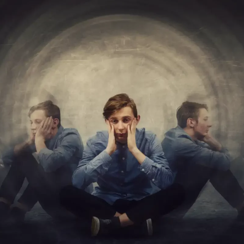 Man seated on the floor experiencing Schizophrenia