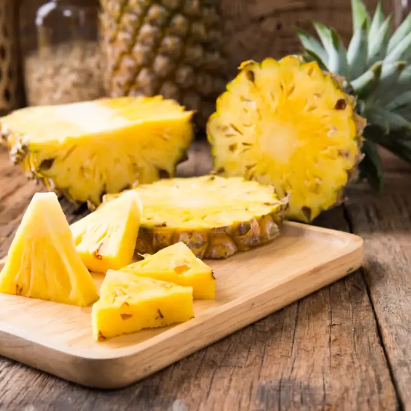 Pineapple on the wooden texture background