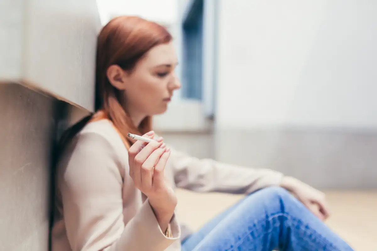 young frustrated depressed woman sitting on the floor